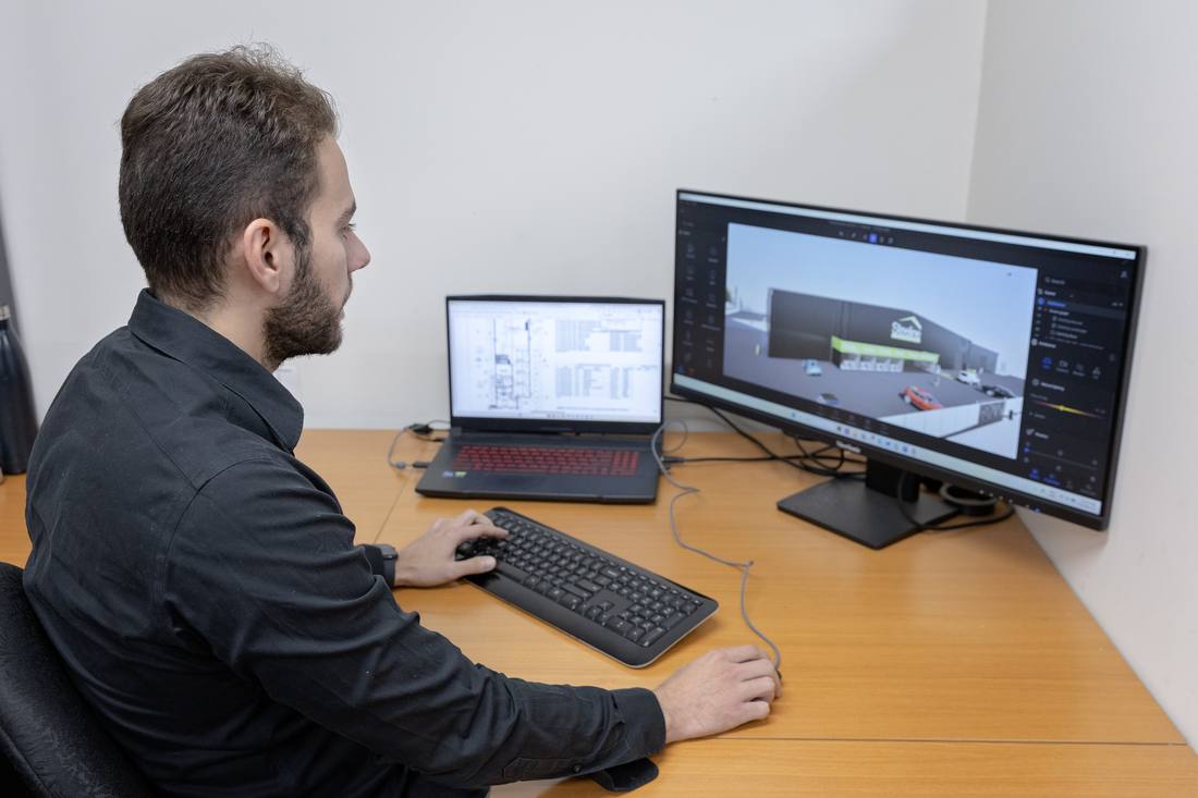 Designer working on a 3D building model in the Blackbird design office
