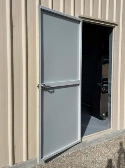 Powder-coated personal access door on a Blackbird Industries shed